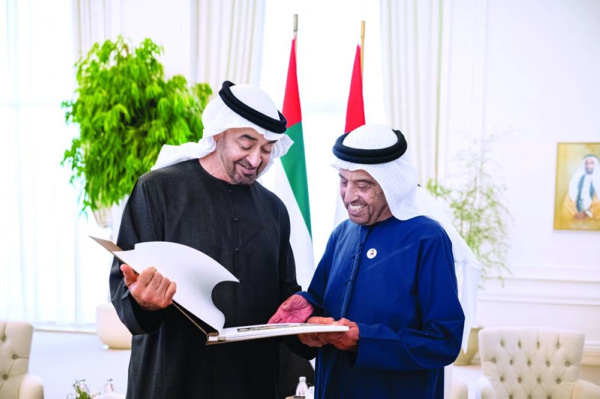 محمد بن زايد يهدي عبدالله السيد الهاشمي كتاباً يضم مجموعة من الصور 