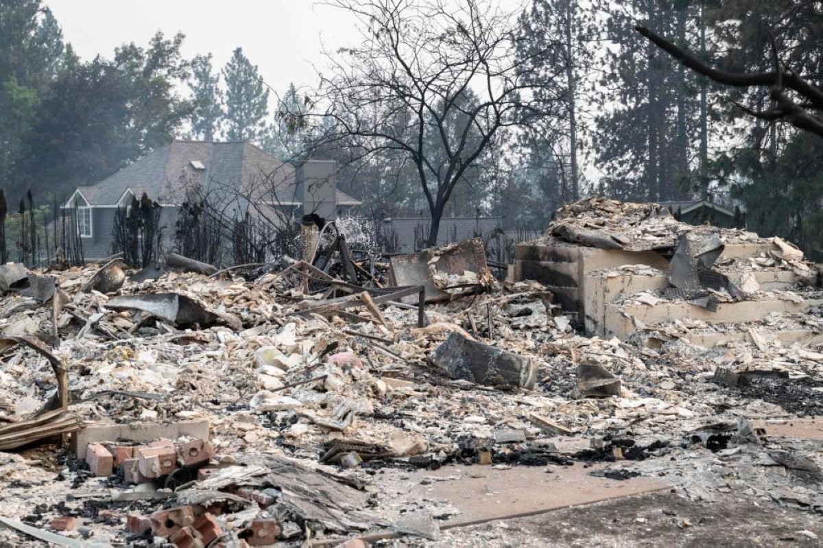 The rubble of a burned out residential home smolders in the Balboa neighborhood of Spokane, Washington, on August 2, 2026. Fast-moving fires left a trail of destruction in the northwestern US city of Spokane on Sunday, with officials reporting hundreds of structures reduced to cinders.
Thousands of people were ordered to evacuate their homes Saturday and overnight into Sunday, as three separate fires broke out in and around the city in the east of Washington state. (Photo by Erick Doxey / AFP)