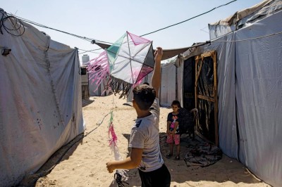 طفل فلسطيني يلعب بطائرة ورقية في مخيم المواصي قرب خان يونس