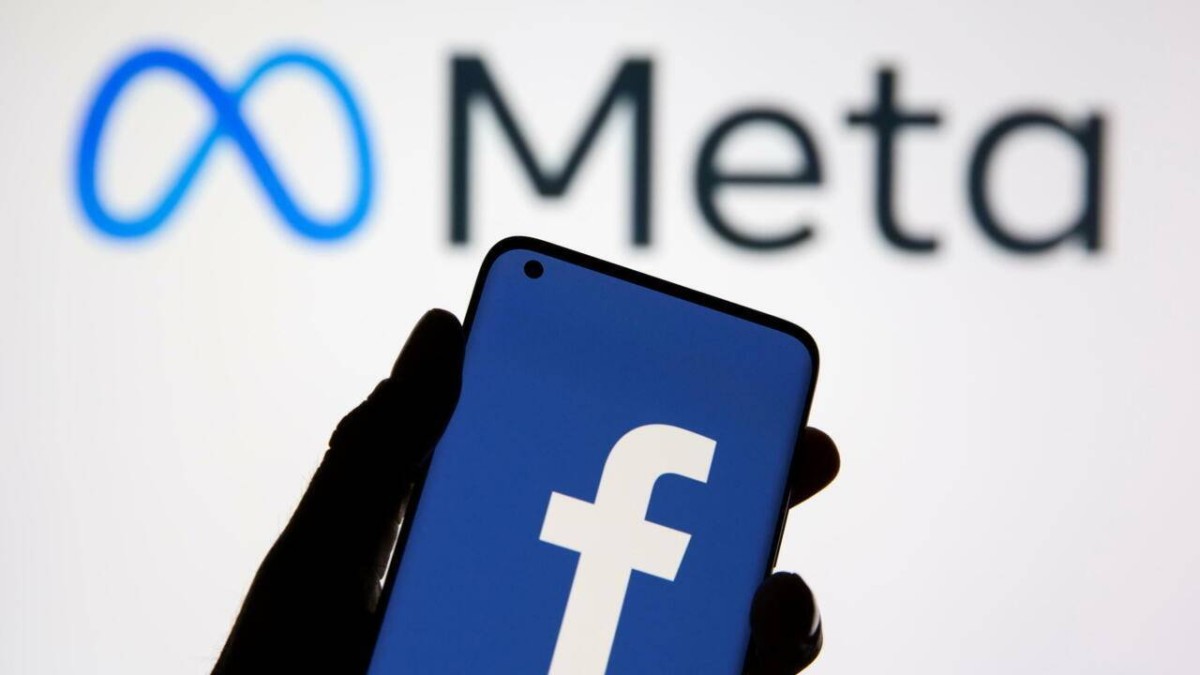 A smartphone with Facebook's logo is seen in front of displayed Facebook's new rebrand logo Meta in this illustration taken October 28, 2021. REUTERS/Dado Ruvic/Illustration