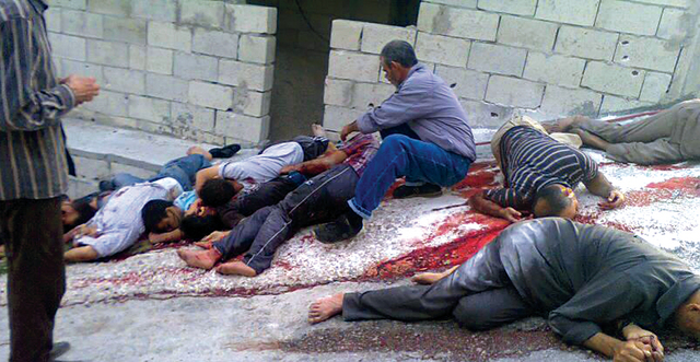 الصورة : جثث في الشارع بعد مجزرة قوات النظام في قرية البيضا   	أ.ب