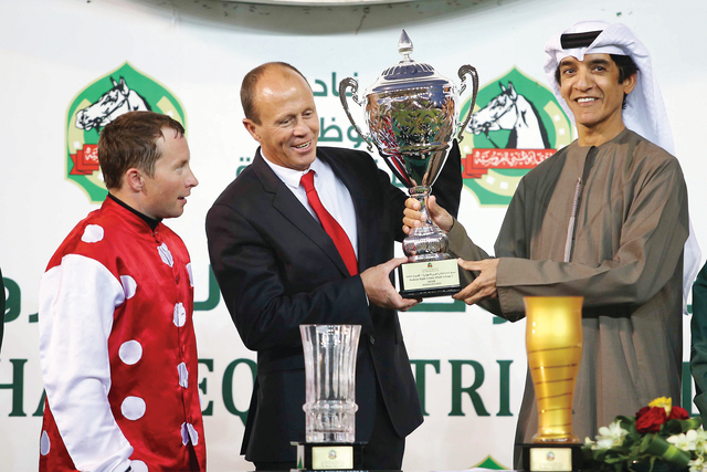 الصورة : عدنان سلطان يسلم كأس التاج الثلاثي لمدرب المهرة «نيمفي دي بون»
