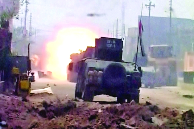 الصورة : ■ مدرعة عراقية تقصف مواقع للإرهابيين في حي الجولان   |  أ.ب