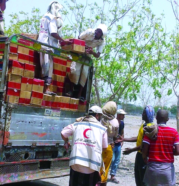 الصورة : موظفو الهلال خلال توزيع المساعدات / وام